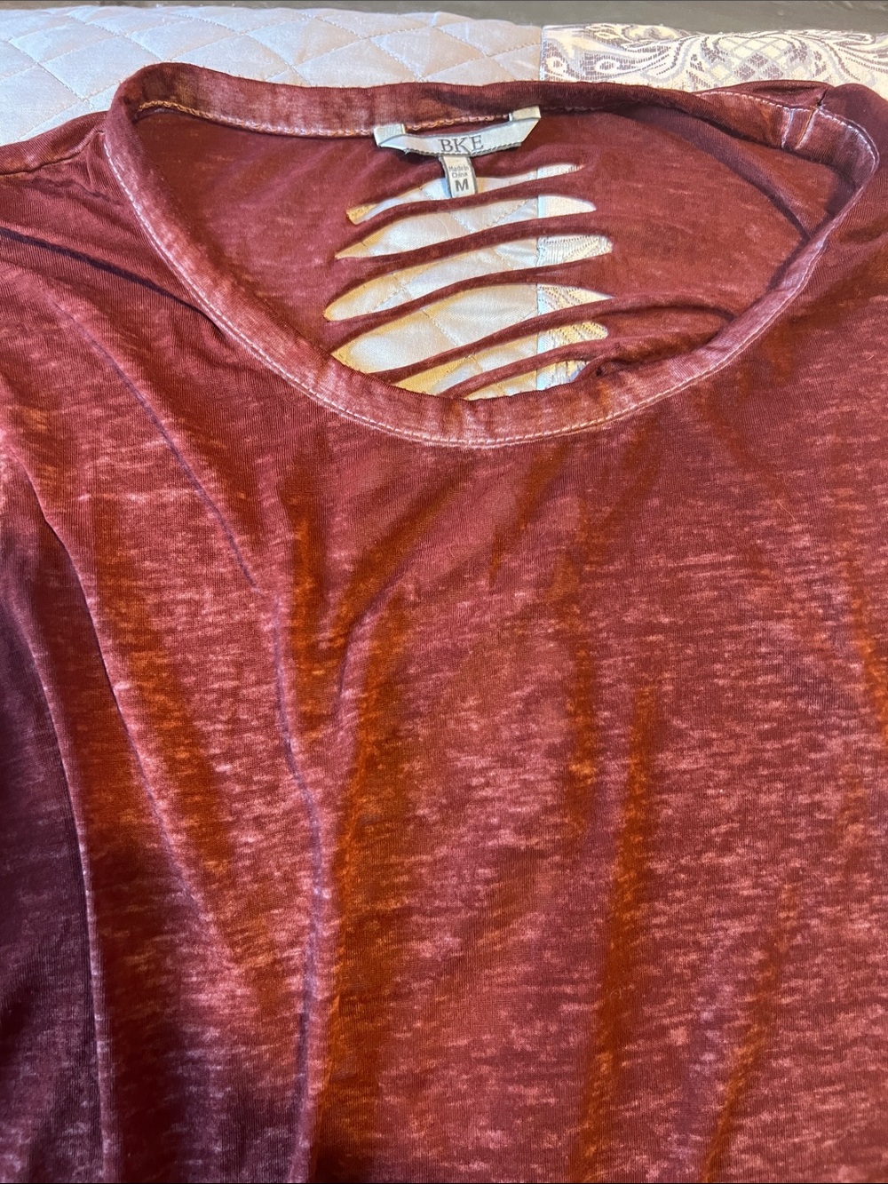 BKE Women's Maroon Distressed Ladder-Front Long Sleeve Top. Ribbed, cut out back